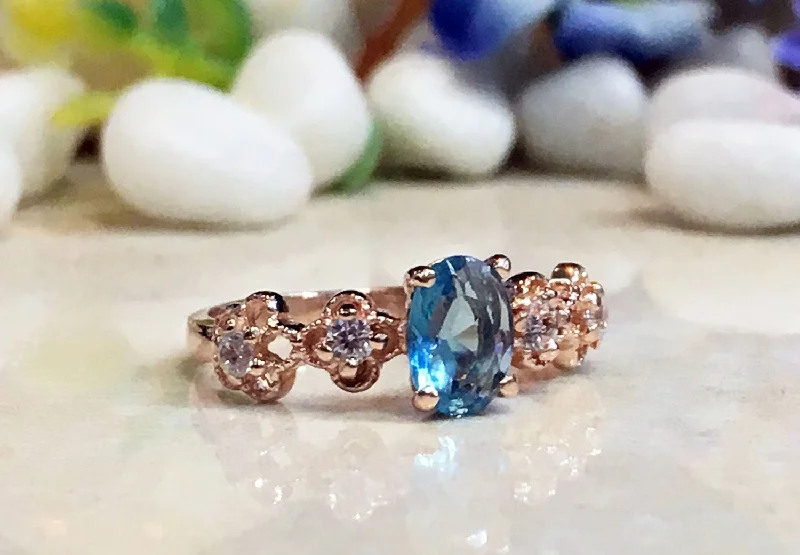 Turquoise Gemstone Rings with Native American - Inspired PatternsBlue Topaz Ring - December Birthstone - Delicate Ring with Oval Blue Topaz Gemstone and Flower Setting with Clear Quartz Accents