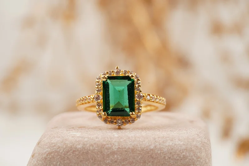 Emerald Gemstone Rings with Diamond - Encrusted HalosEmerald Cut Cluster Halo Engagement Ring